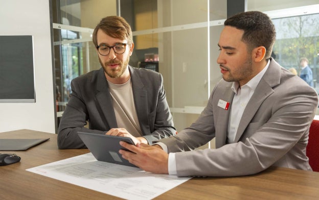 two people looking at tablet at a branch