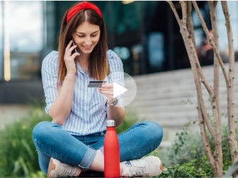 girl looking at credit or debit card