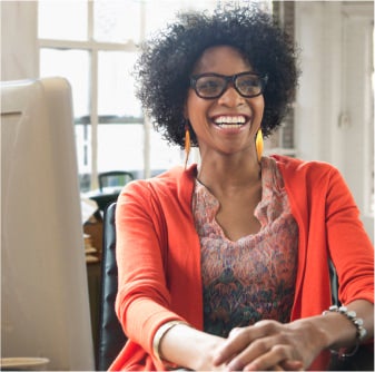 Woman smiling in front of computer