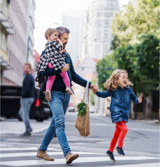 Father and two children crossing street