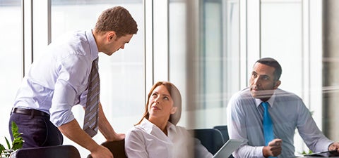 three people in conference room
