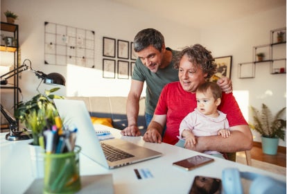 family looking at laptop