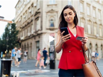 woman on street looking at cellphone