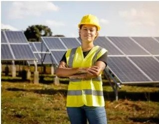 woman standing Infront of solar panels