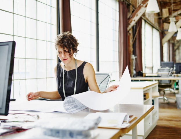 Woman looking at paperwork on desk