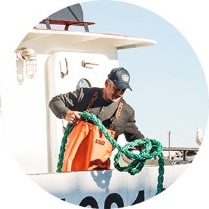 man on boat holding rope