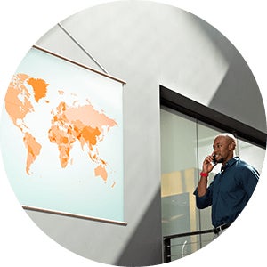 Man looking at large map on wall while talking on phone