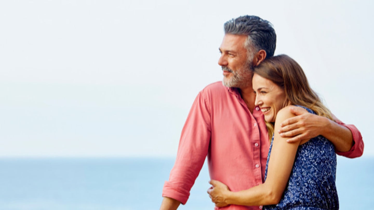 couple on a balcony overlooking ocean