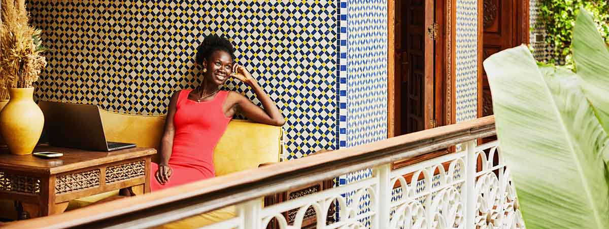 woman sitting on a balcony in upscale hotel