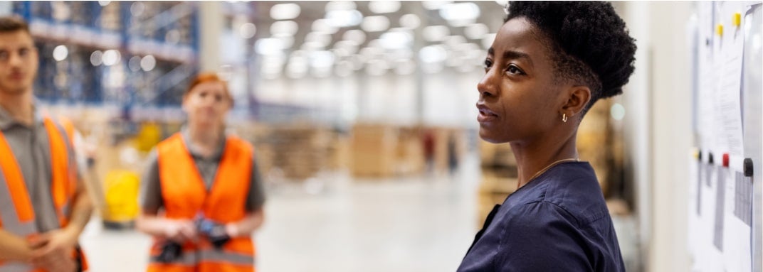 woman speaking to others in warehouse