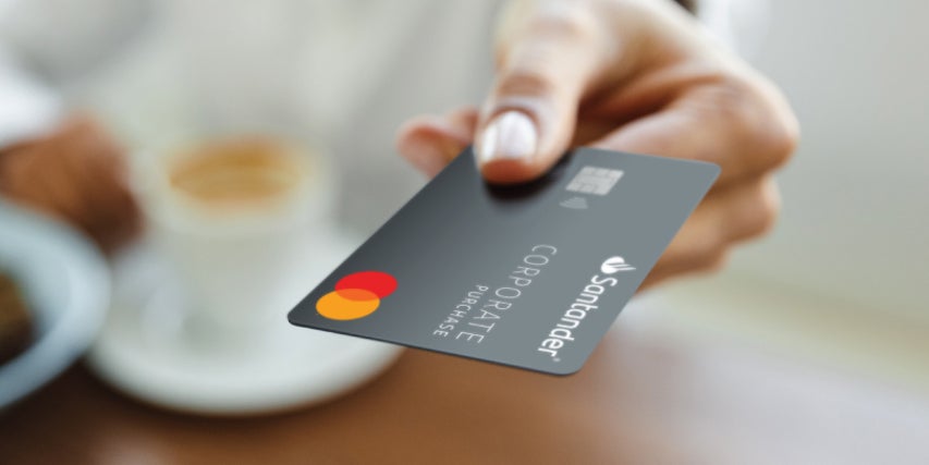 Santander travel and entertainment credit card resting on laptop image