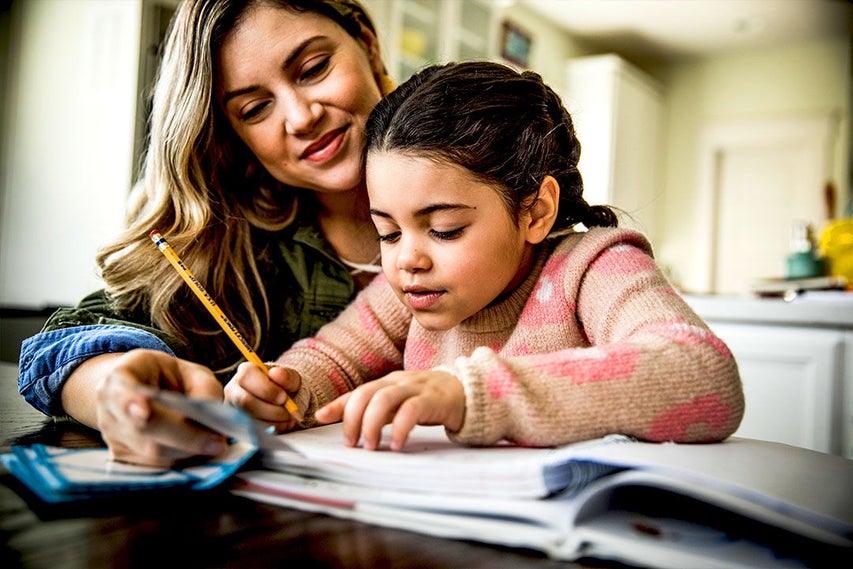 woman doing homework with child