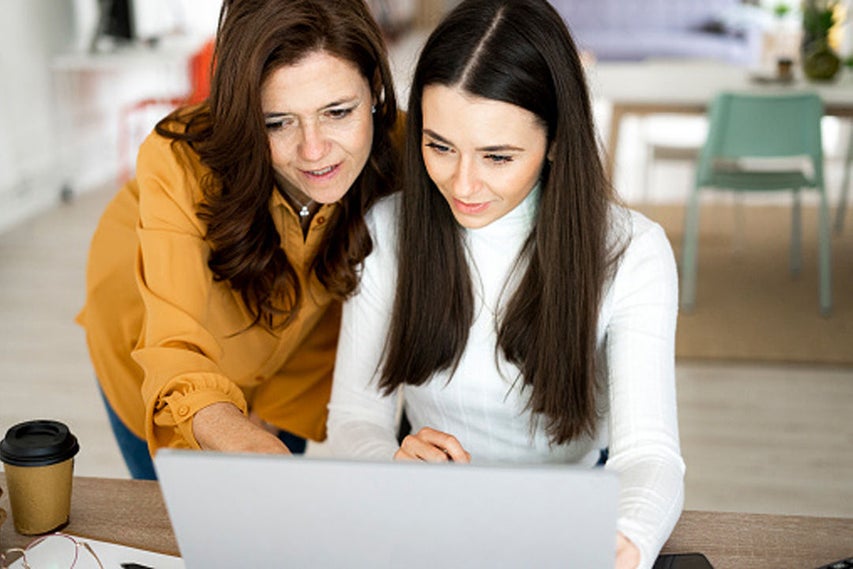 woman and girl using laptop