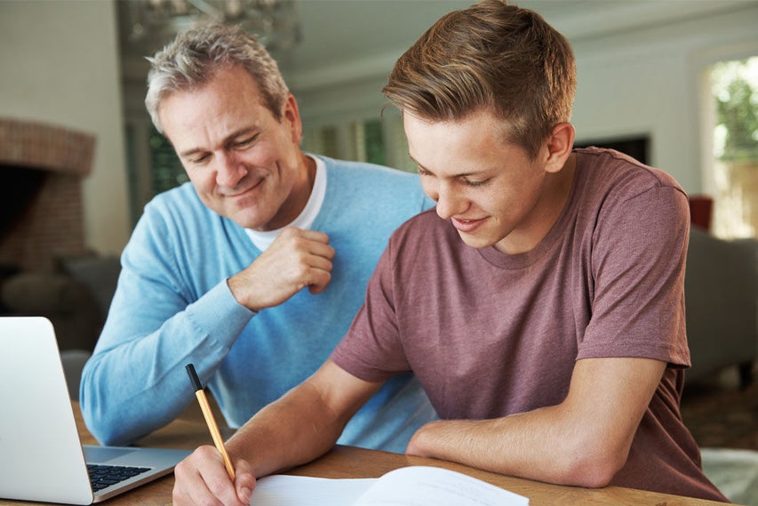 man and child doing homework