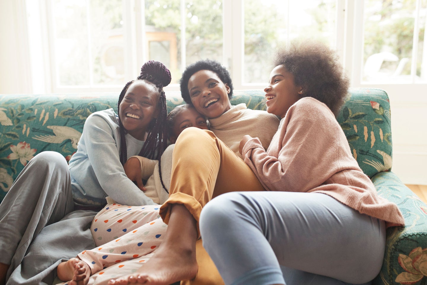 Family of four on couch laughing
