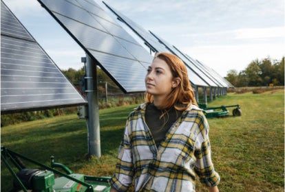 woman walking by solar panels