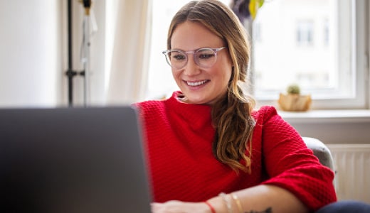 Woman smiling looking at her laptop